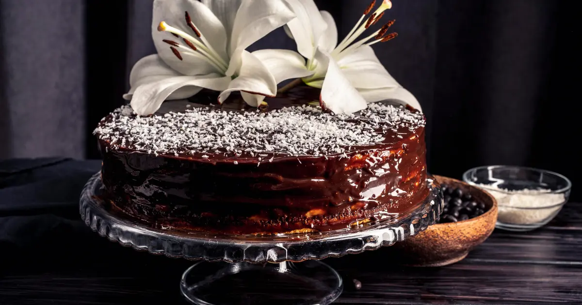 Gordon Ramsay's famous chocolate cake topped with chocolate ganache and garnished with fresh raspberries and mint leaves.